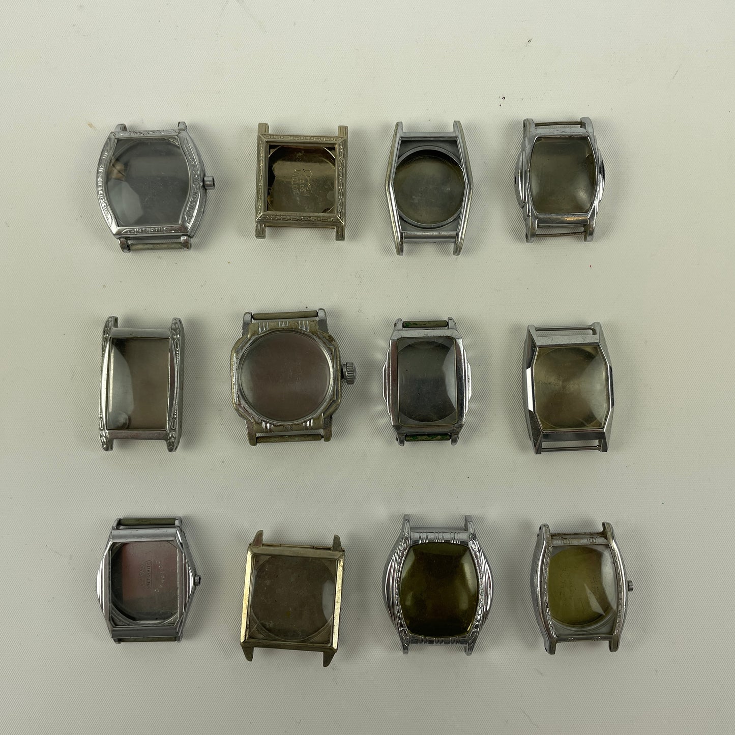 Jan Lot 63- Twelve Vintage Fancy Metal Wristwatch Cases
