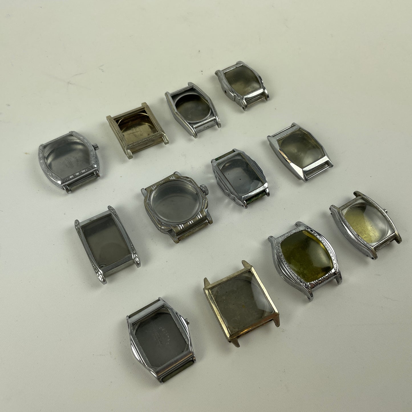 Jan Lot 63- Twelve Vintage Fancy Metal Wristwatch Cases