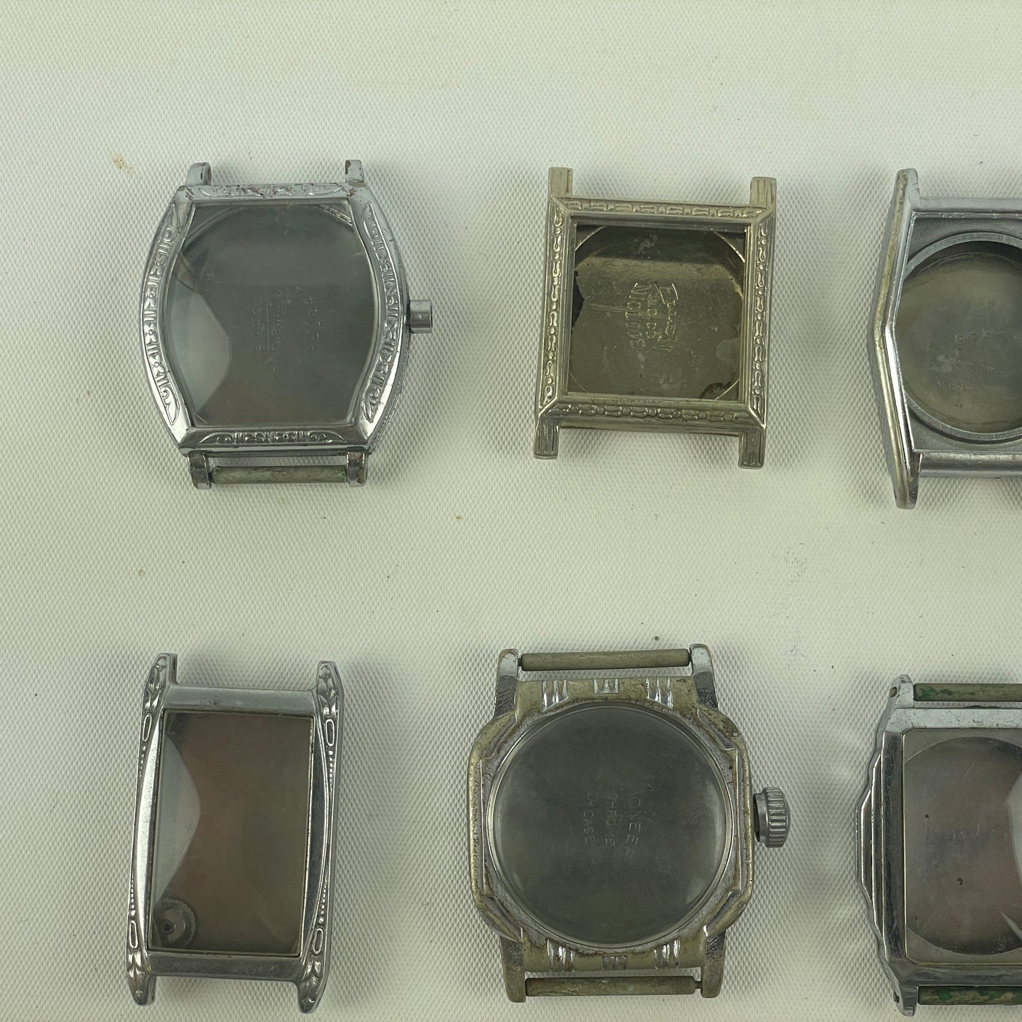 Jan Lot 63- Twelve Vintage Fancy Metal Wristwatch Cases