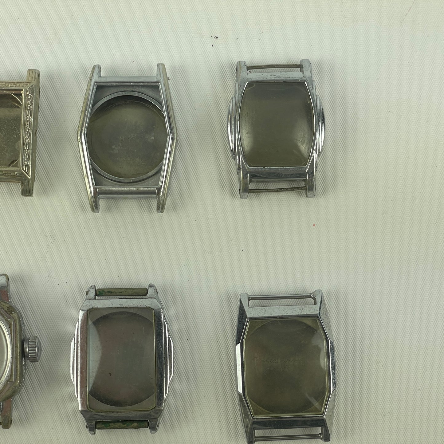 Jan Lot 63- Twelve Vintage Fancy Metal Wristwatch Cases