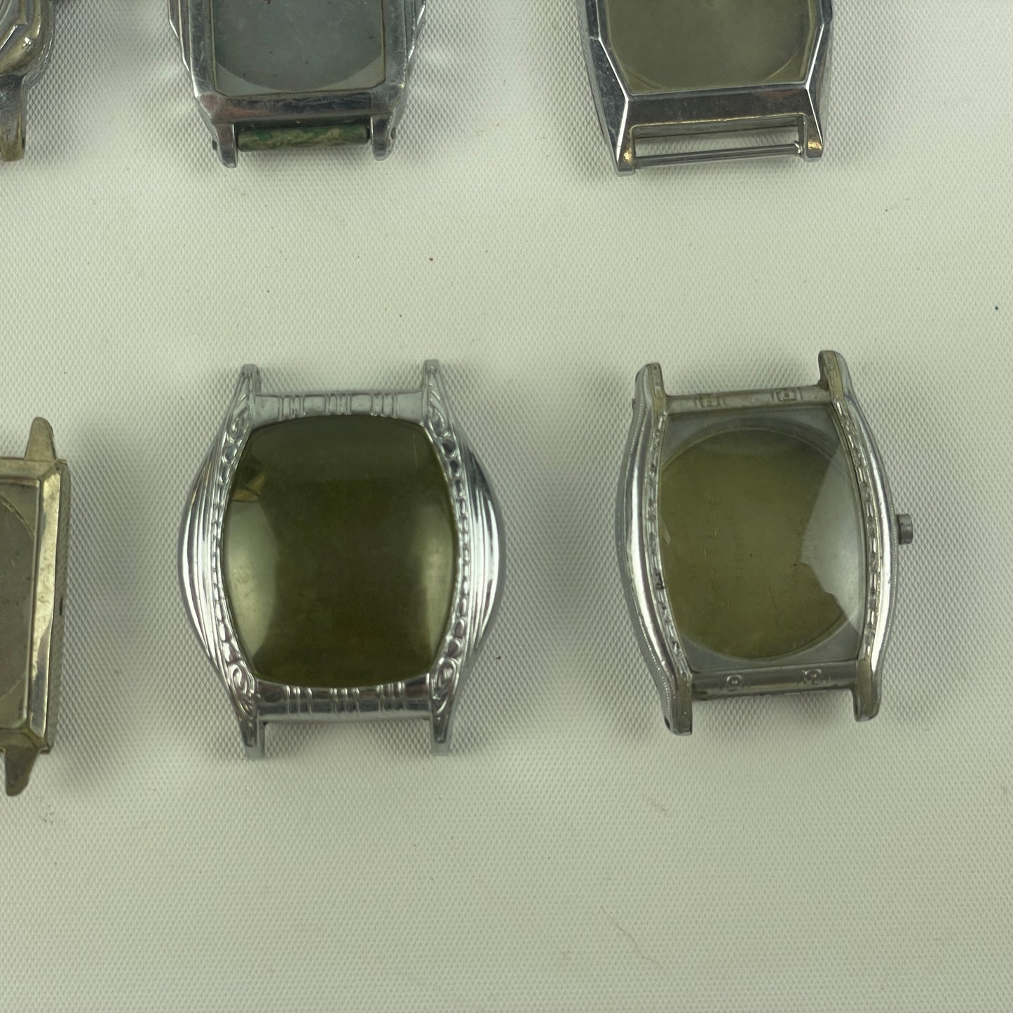 Jan Lot 63- Twelve Vintage Fancy Metal Wristwatch Cases