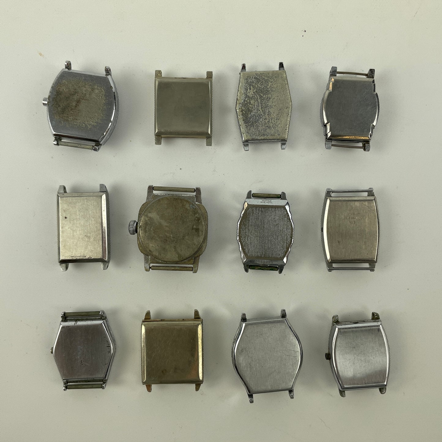 Jan Lot 63- Twelve Vintage Fancy Metal Wristwatch Cases
