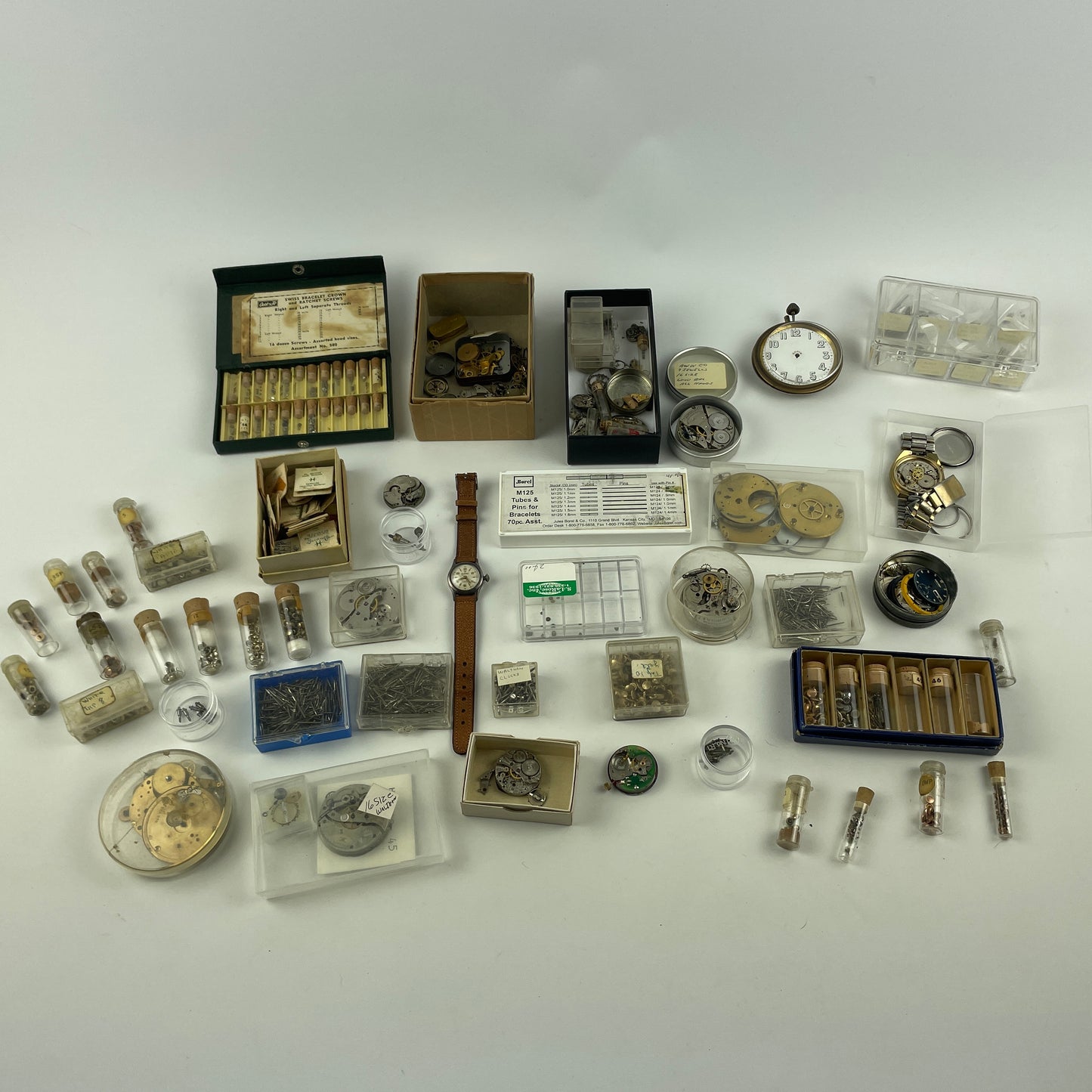 Lot 52- Assortment of Pocket Watch Movements, Wristwatch Stems, Crowns, etc.