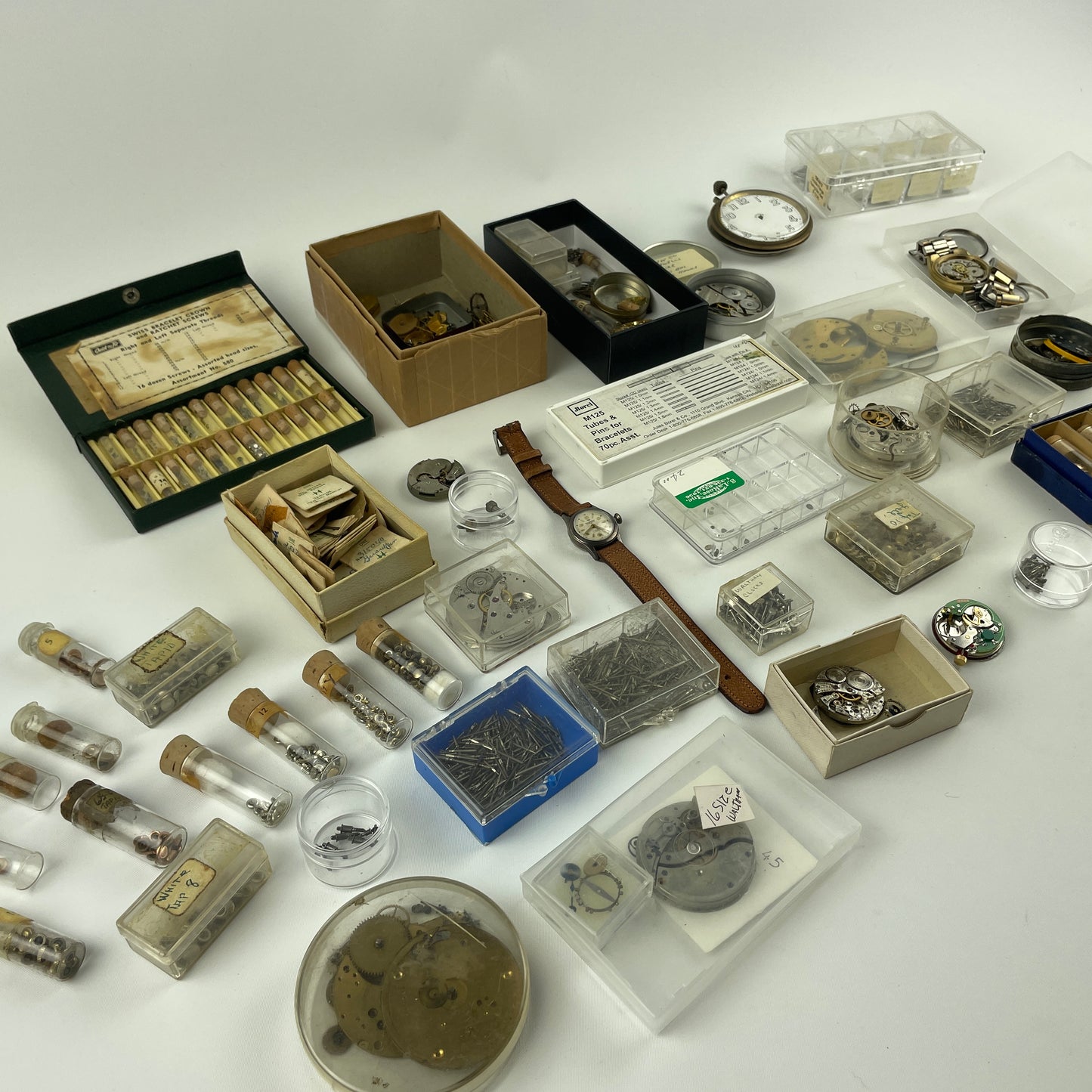 Lot 52- Assortment of Pocket Watch Movements, Wristwatch Stems, Crowns, etc.