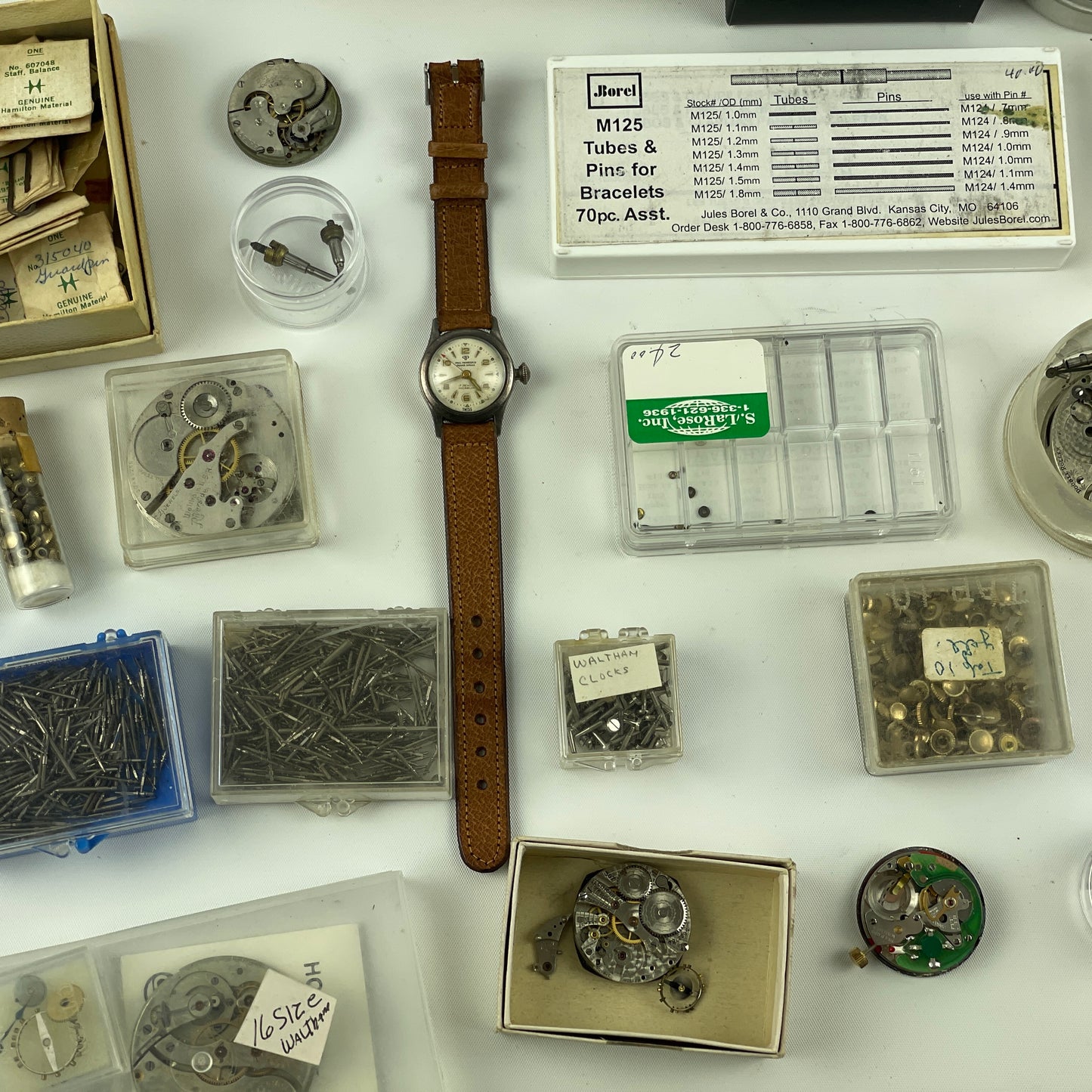 Lot 52- Assortment of Pocket Watch Movements, Wristwatch Stems, Crowns, etc.