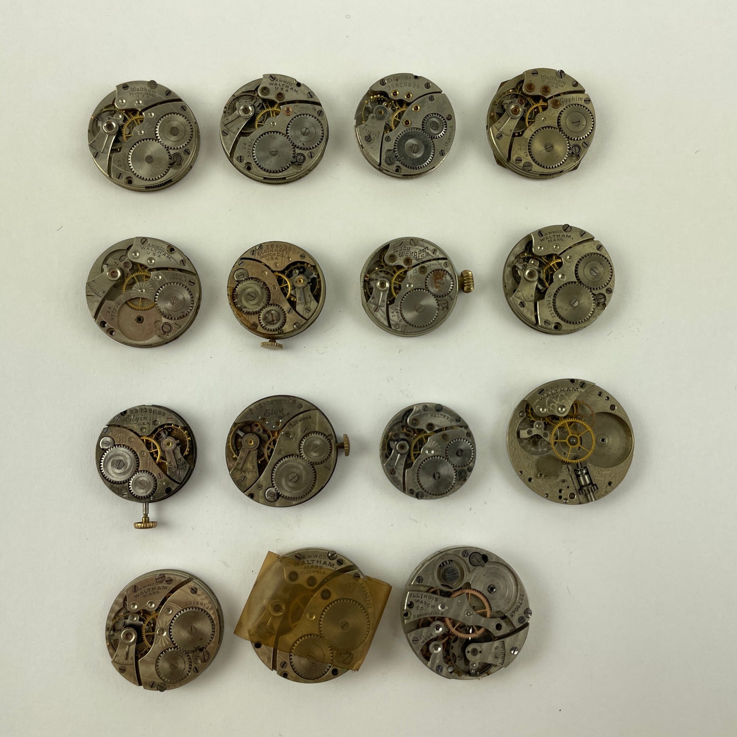 Feb Lot 39- Waltham & Elgin Lapel & Wristwatch Movements