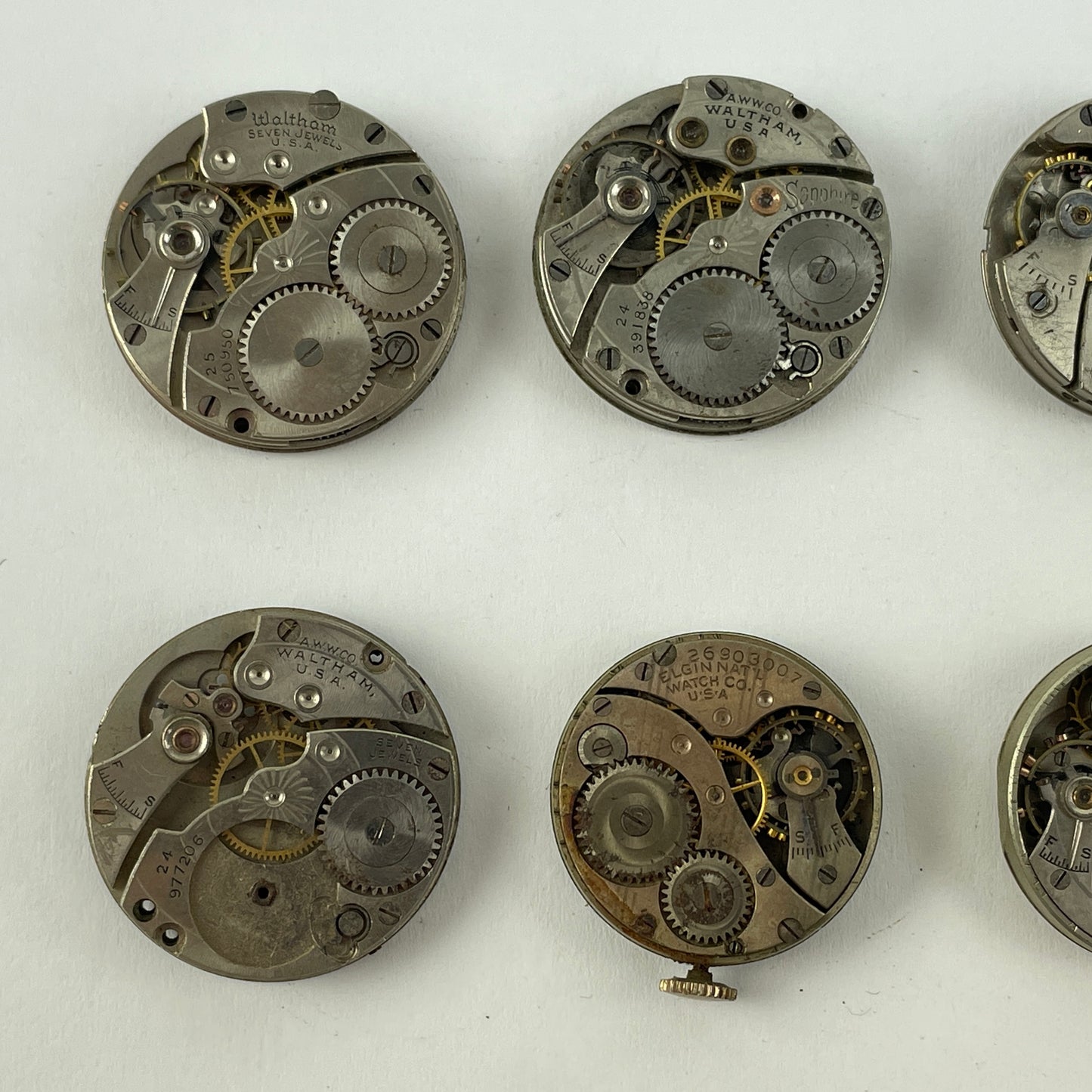 Feb Lot 39- Waltham & Elgin Lapel & Wristwatch Movements