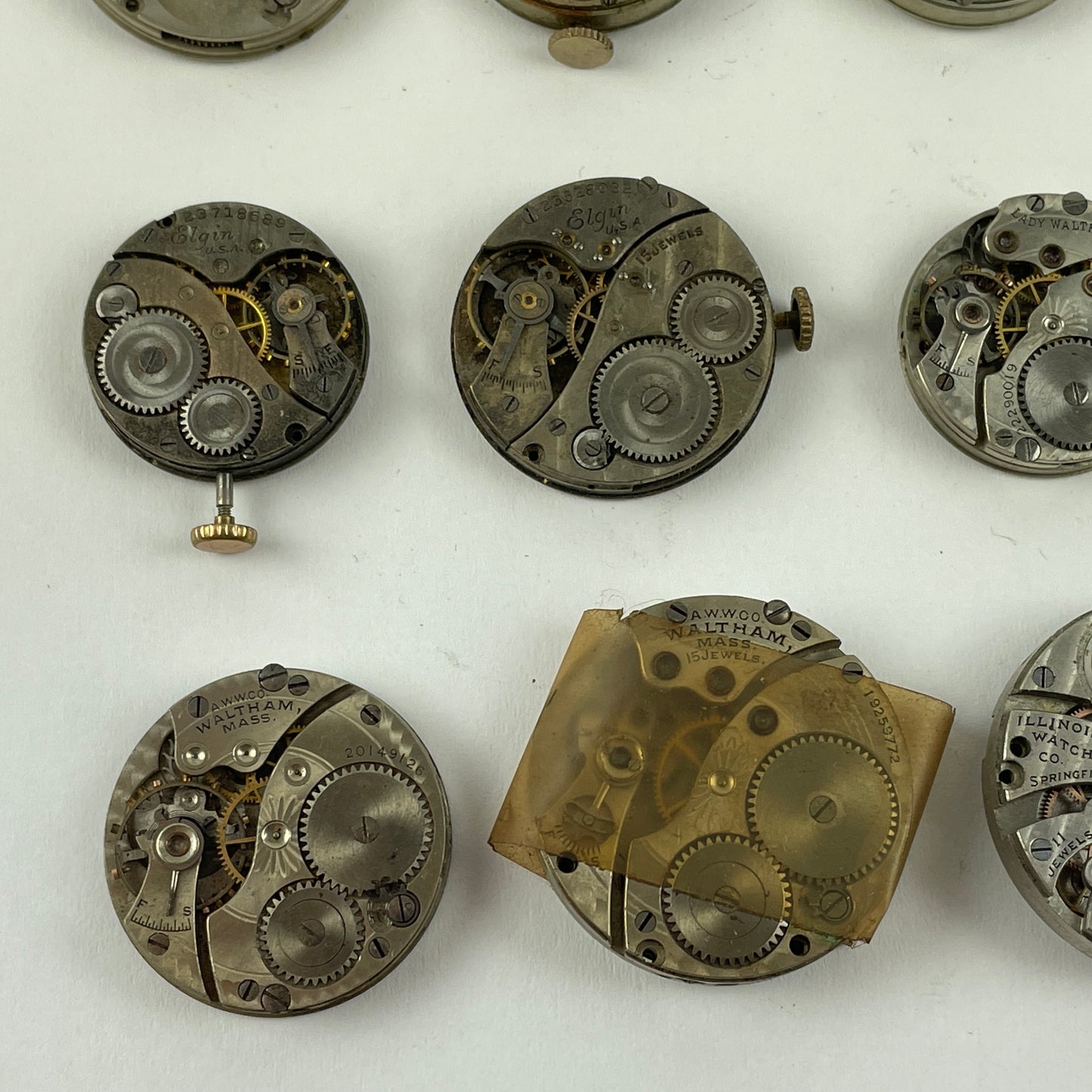 Feb Lot 39- Waltham & Elgin Lapel & Wristwatch Movements
