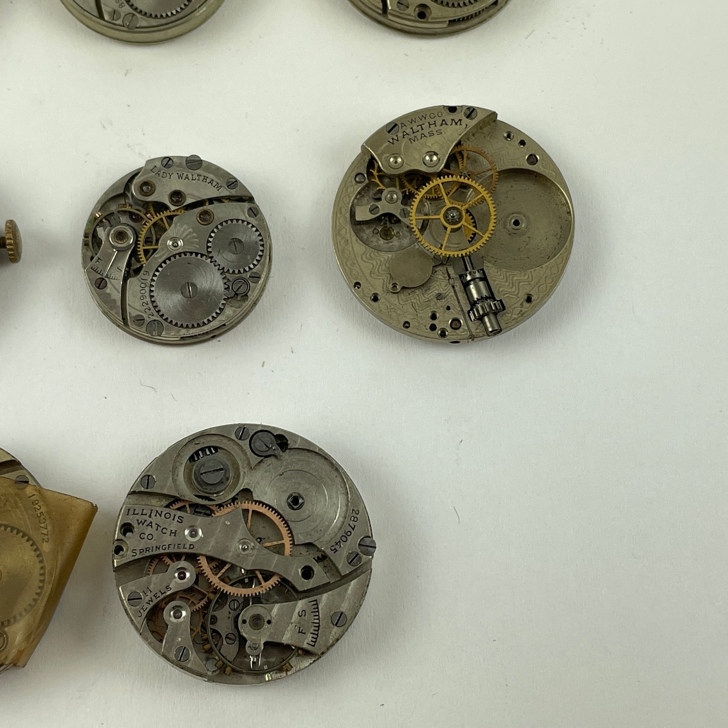 Feb Lot 39- Waltham & Elgin Lapel & Wristwatch Movements
