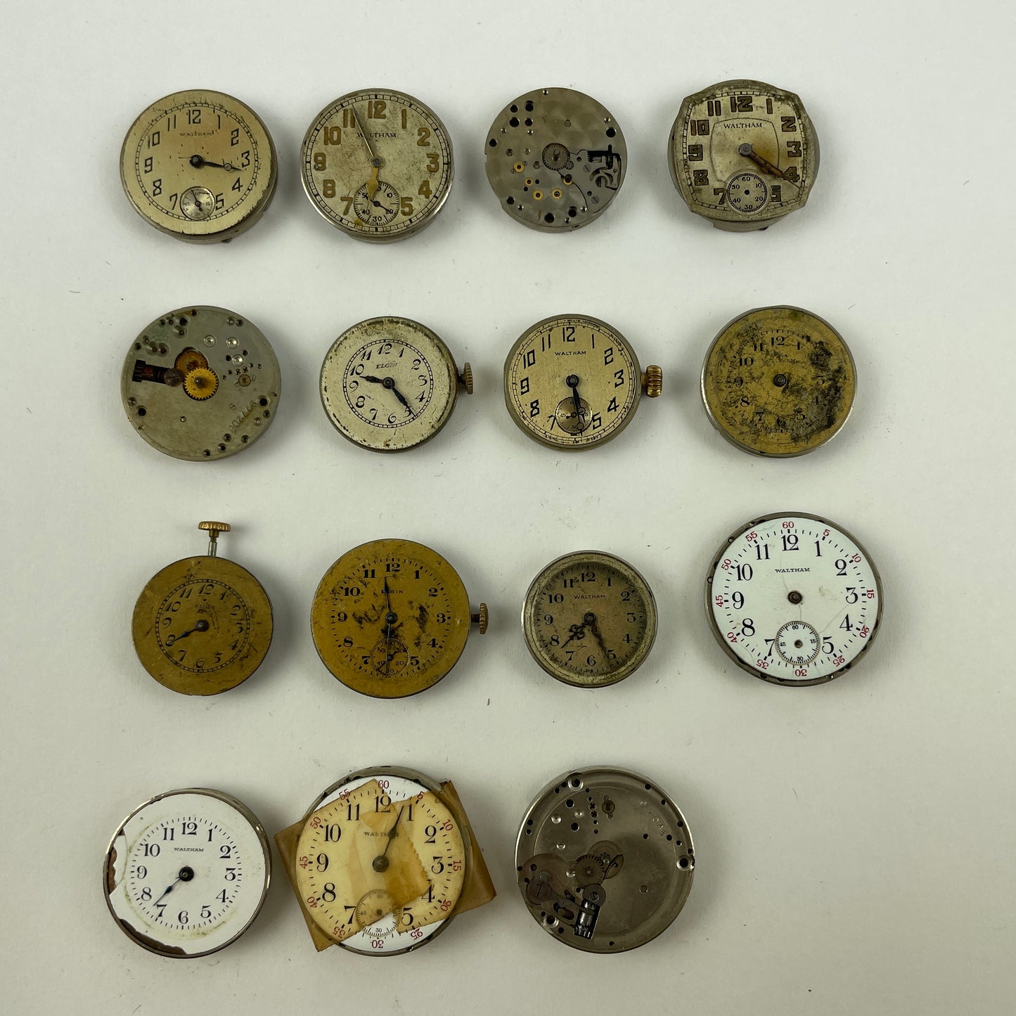 Feb Lot 39- Waltham & Elgin Lapel & Wristwatch Movements