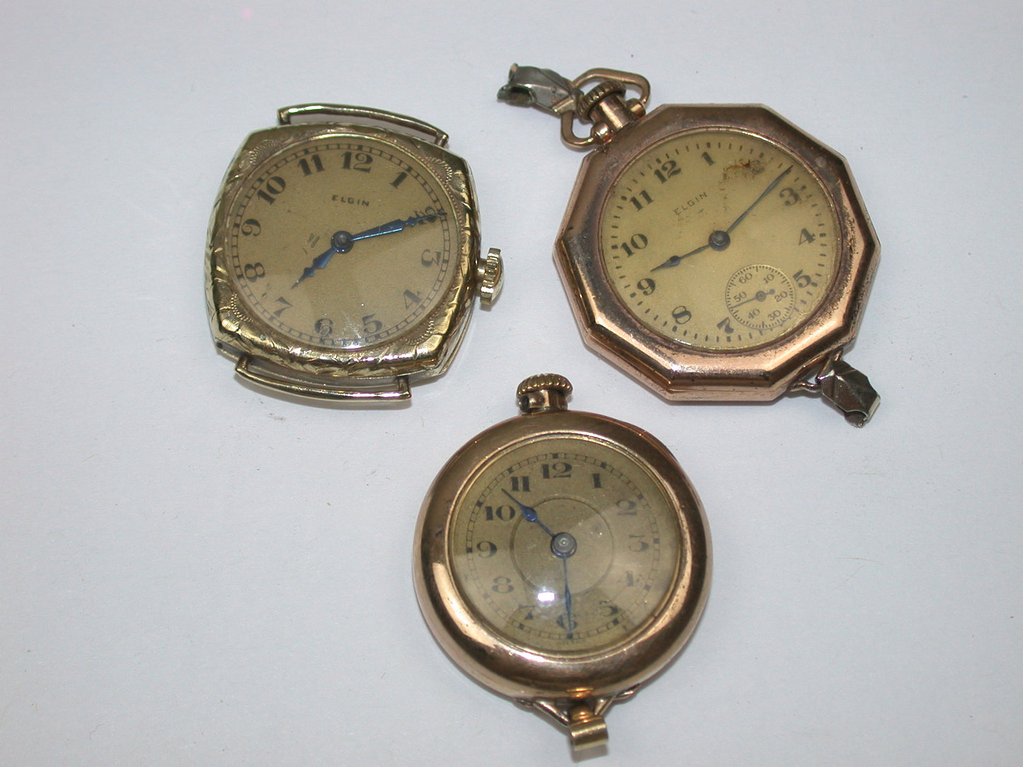 Lot 6- Three Elgin Yellow Gold-Filled Lapel Watches & Wristwatch
